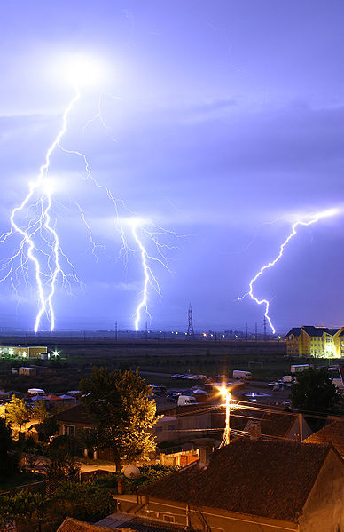  Cloud to ground Lightning in the global atmospheric electrical circuit. This is an example of plasma present at Earth's surface. Typically, lightning discharges 30,000 amperes, at up to 100 million volts, and emits light, radio waves, x-rays and even gamma rays. Plasma temperatures in lightning can approach 28,000 kelvins. 